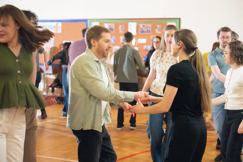 a group of people dancing in a room