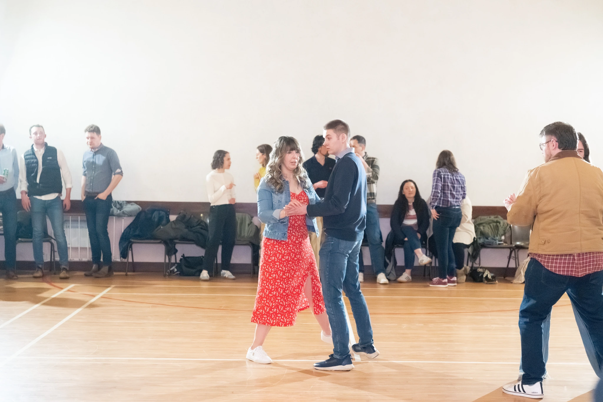 a group of people dancing in a room full of people