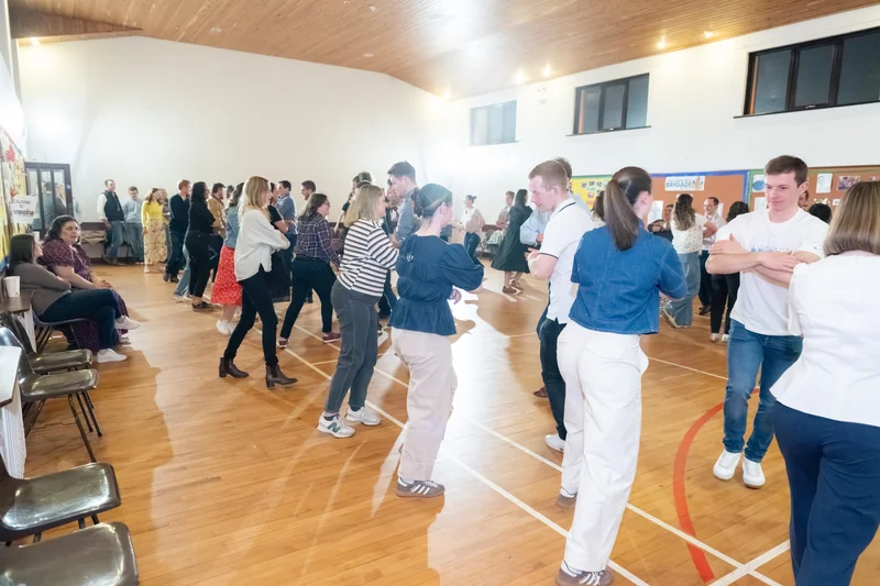 a group of people standing in a room full of people