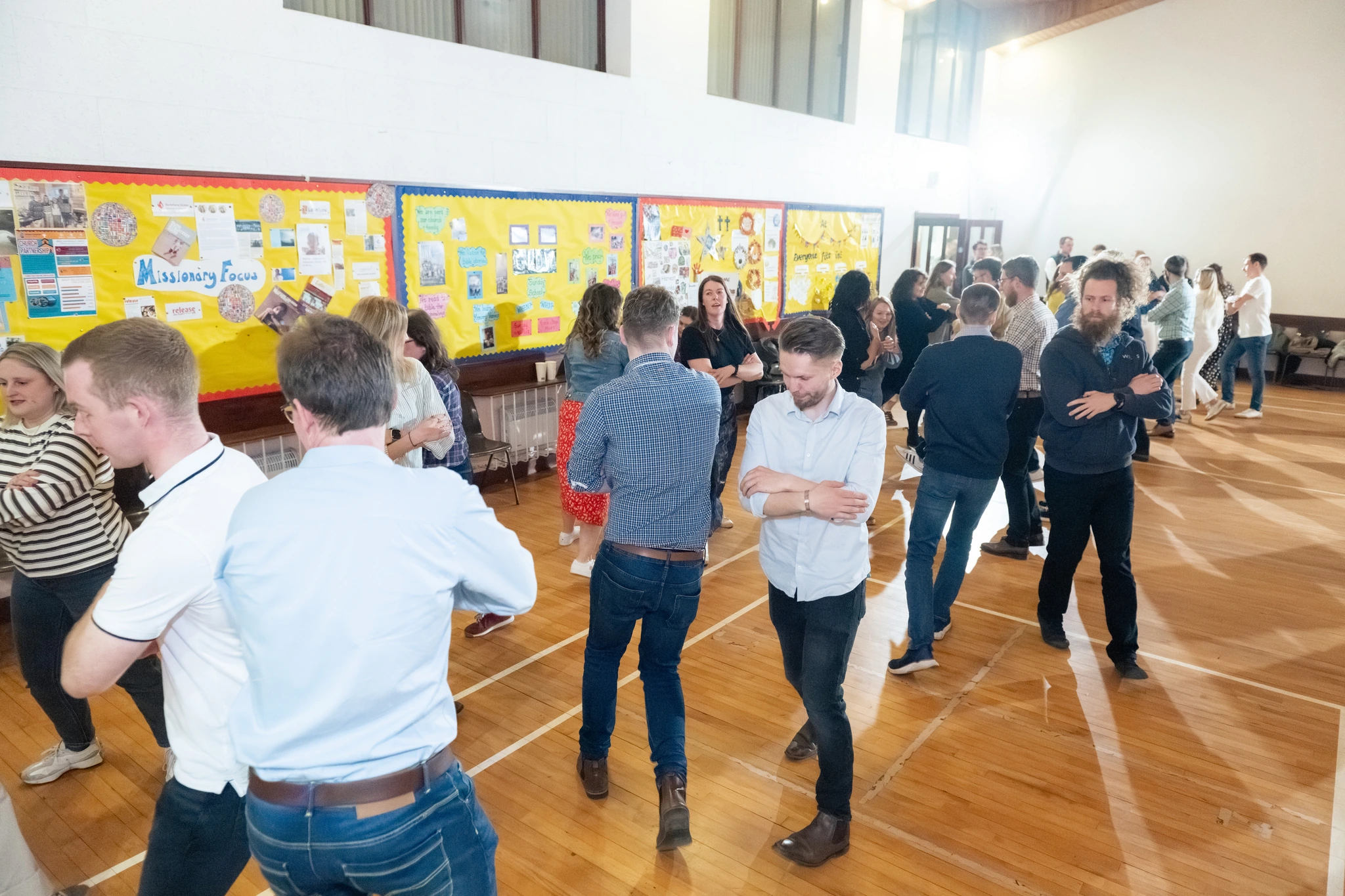 a group of people standing in a room full of people