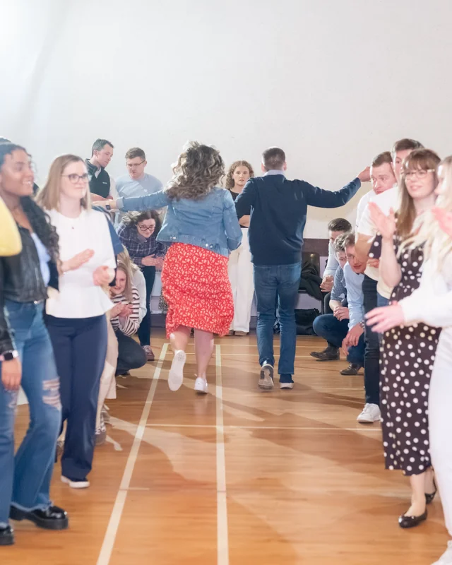 a group of people dancing in a room