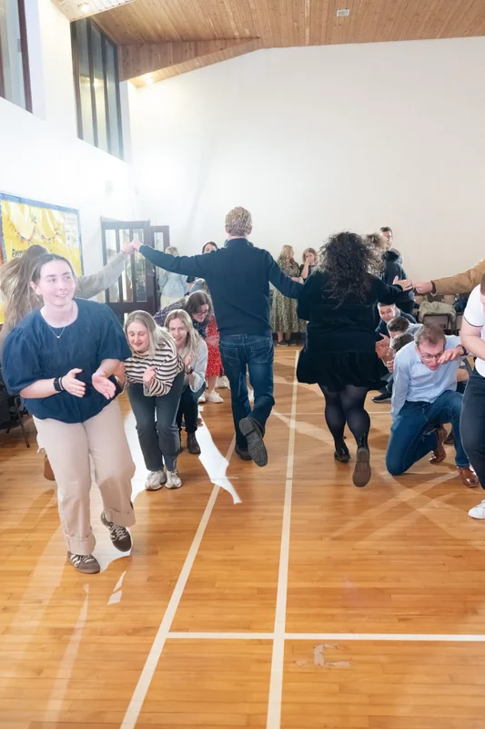 a group of people playing a game on a wooden floor