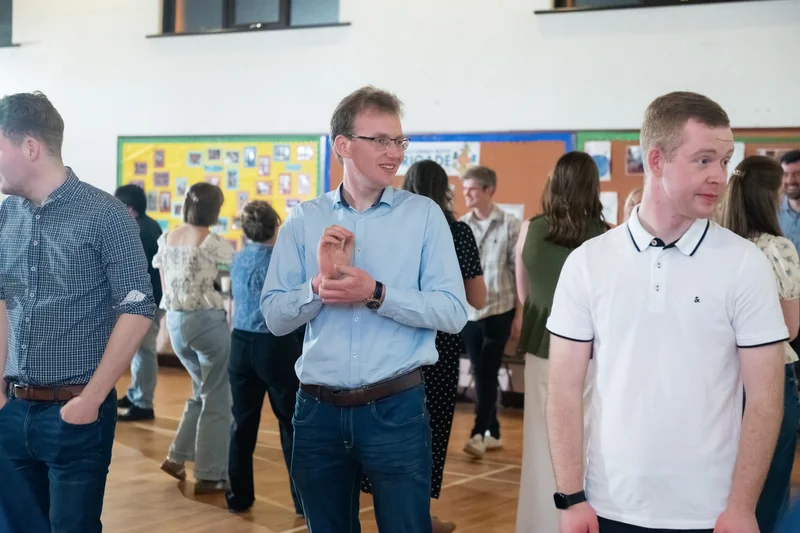 a group of people standing in a room full of people