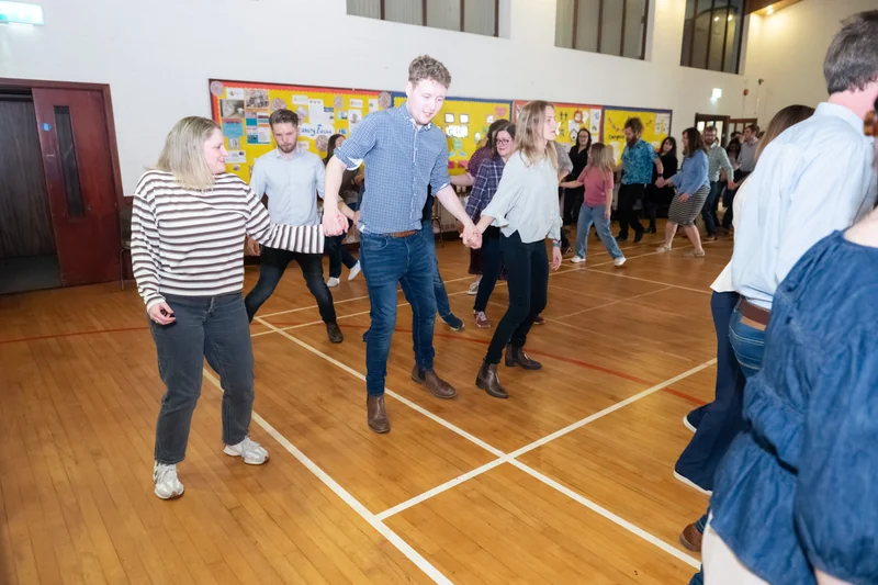 a group of people dancing in a gymnasium