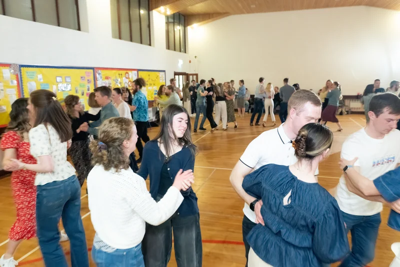 a group of people dancing in a gymnasium