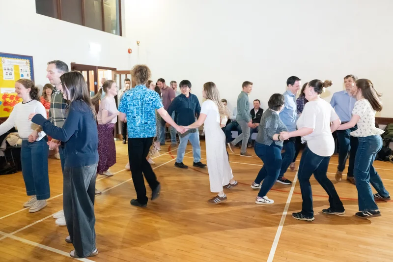 a group of people dancing in a gymnasium
