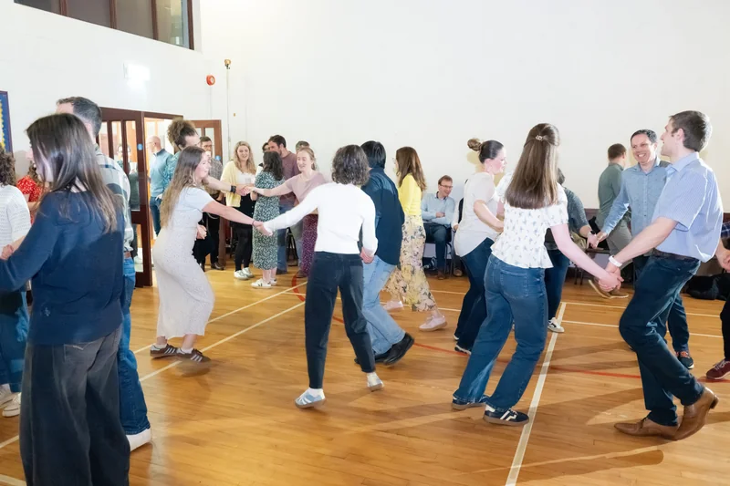 a group of people dancing in a room