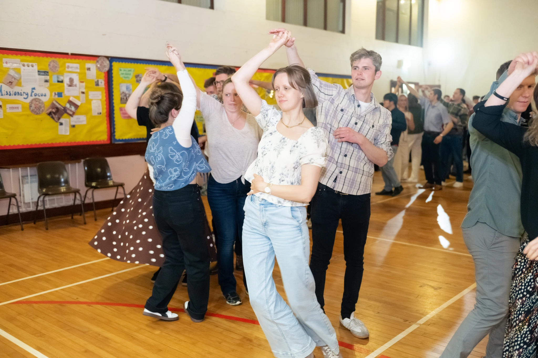 a group of people dancing in a gymnasium