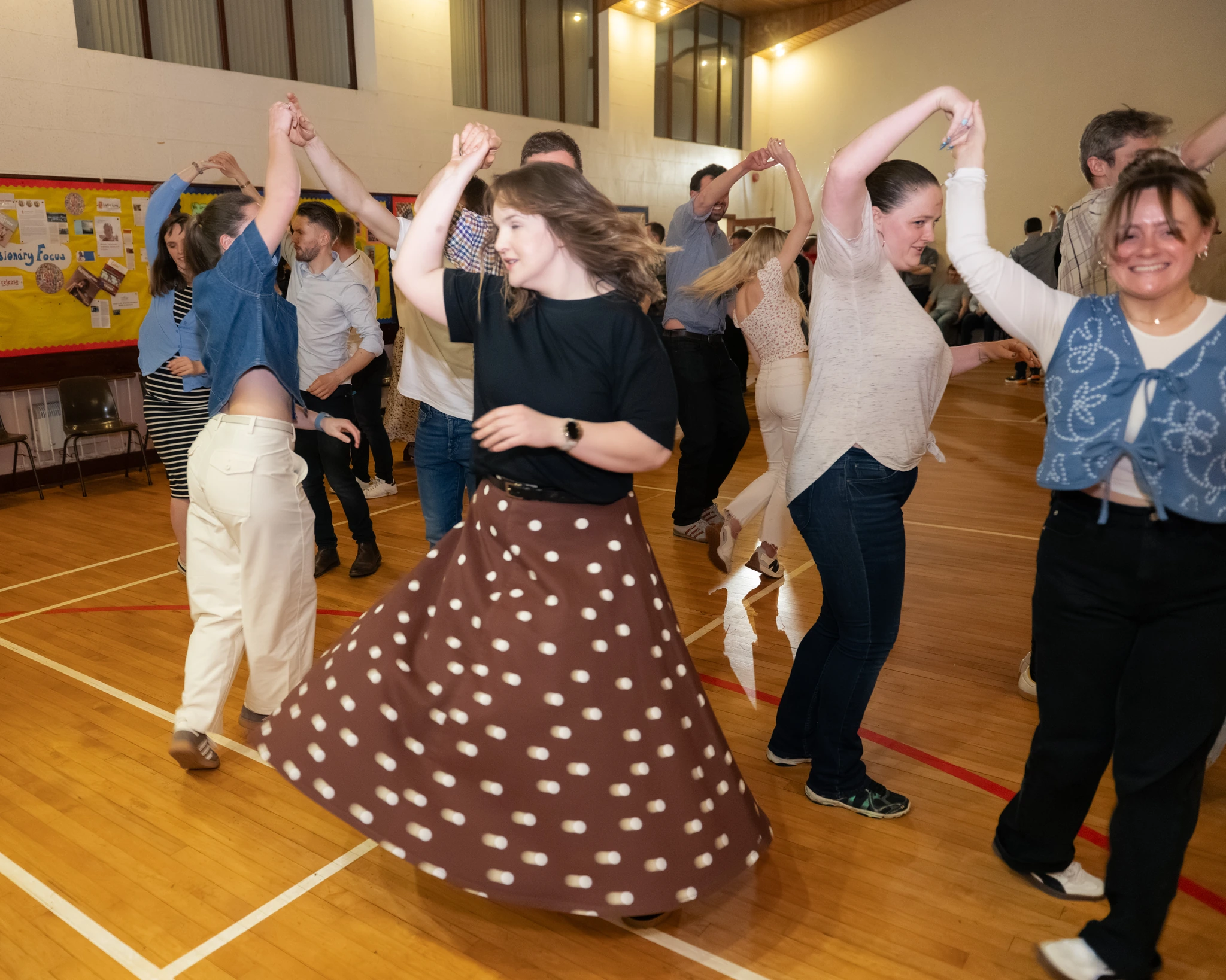 a group of people dancing in a gymnasium
