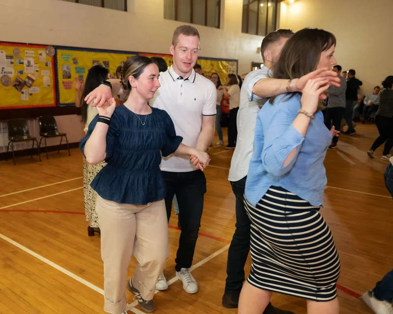 a group of people dancing in a gymnasium