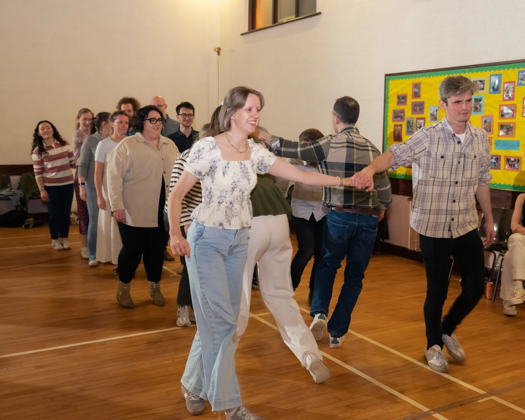 a group of people dancing in a room full of people