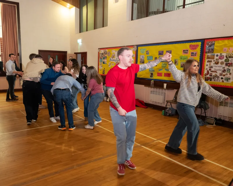a group of people dancing in a room