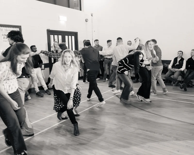 a group of people dancing in a gymnasium