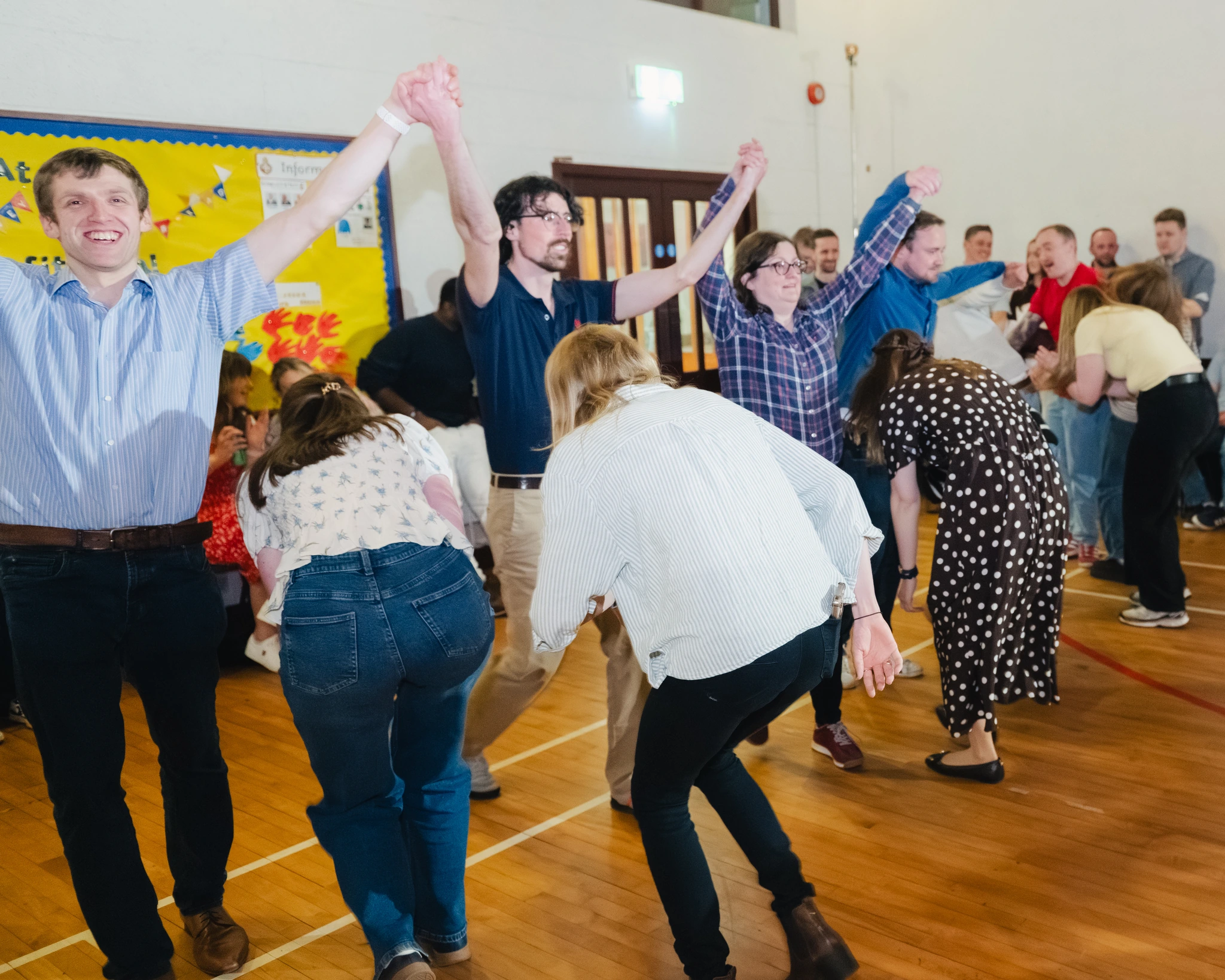 a group of people dancing in a gymnasium