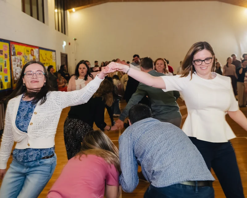 a group of people dancing in a gymnasium