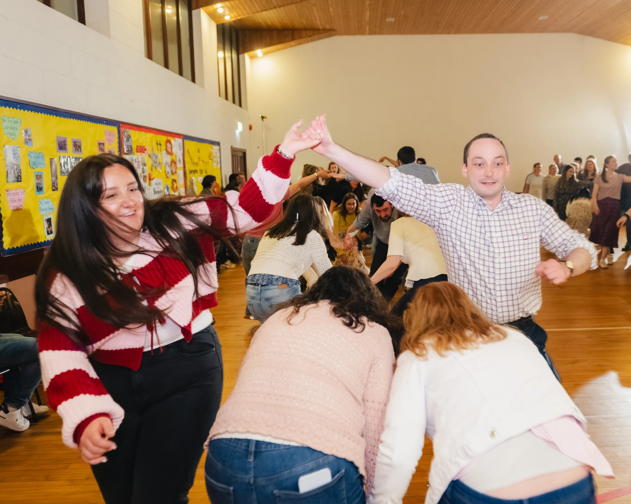 a group of people dancing on a dance floor in a gymnasium