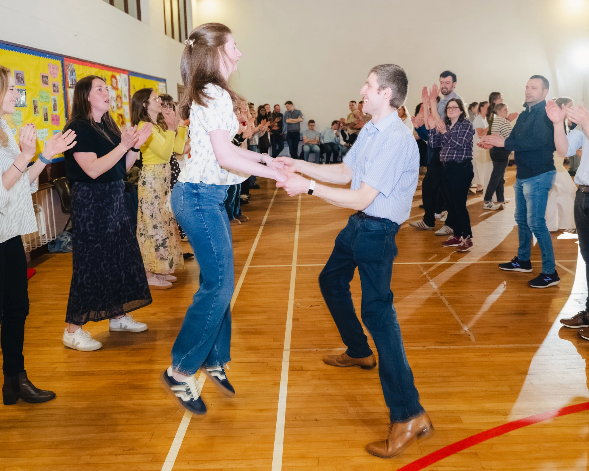 a man and woman dancing on a dance floor in front of a crowd of people