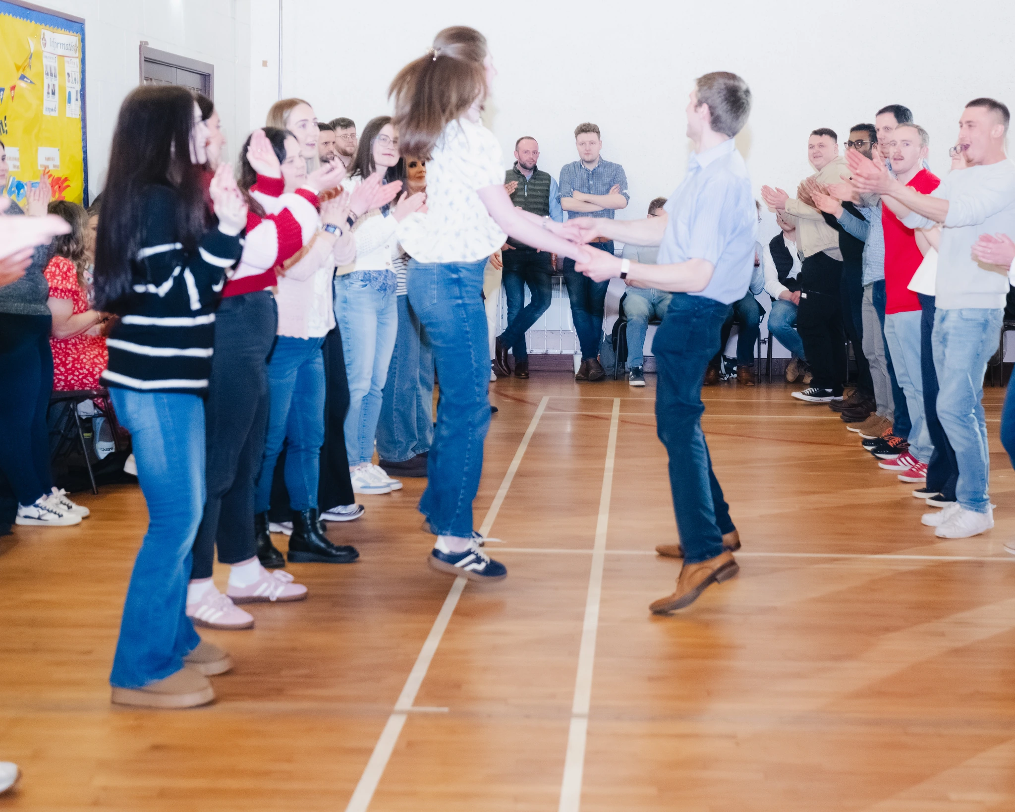 a group of people dancing on a floor in a room