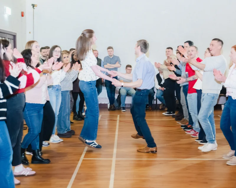 a group of people dancing in a room