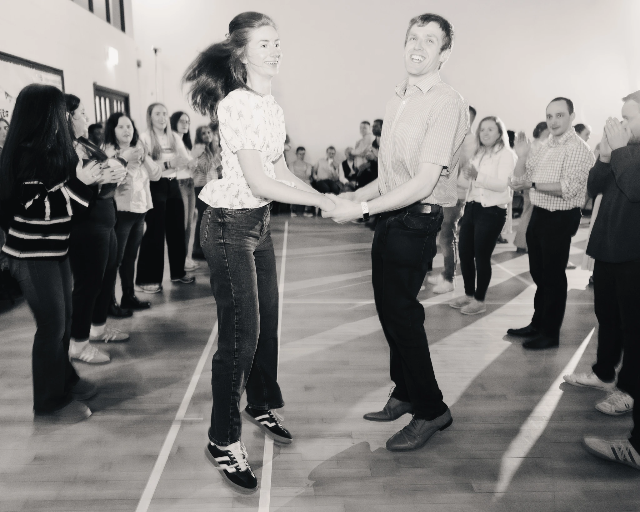 a man and woman dancing on a dance floor in front of a crowd of people