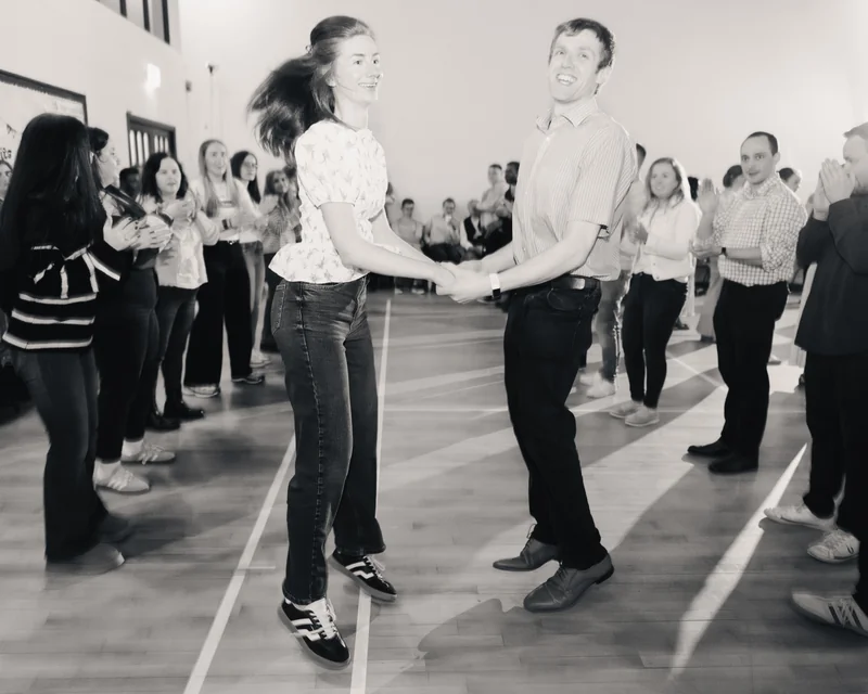 a man and woman dancing on a dance floor in front of a crowd of people