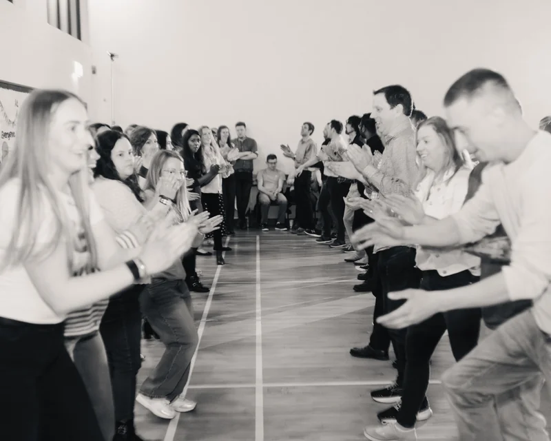 a group of people dancing in a room