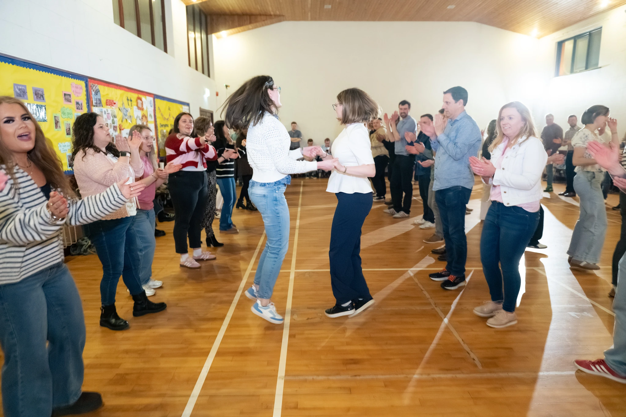 a group of people dancing in a gymnasium