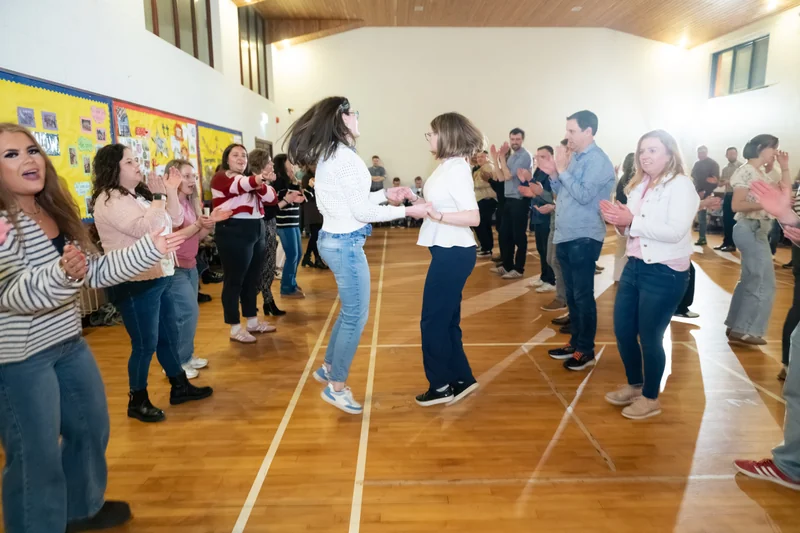 a group of people dancing in a gymnasium
