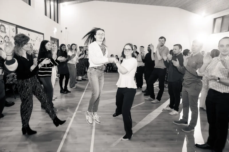 a group of people dancing in a gymnasium