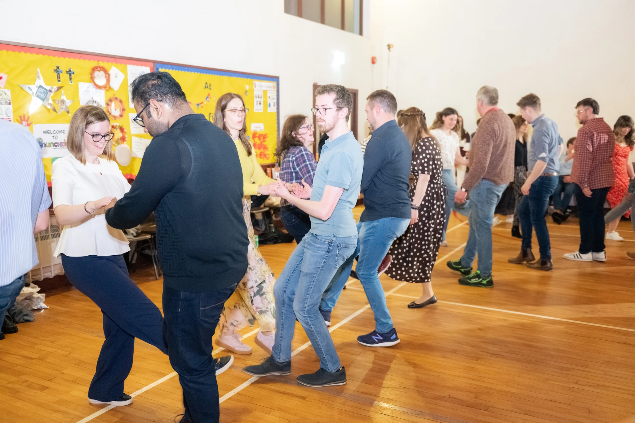 a group of people dancing in a room full of people
