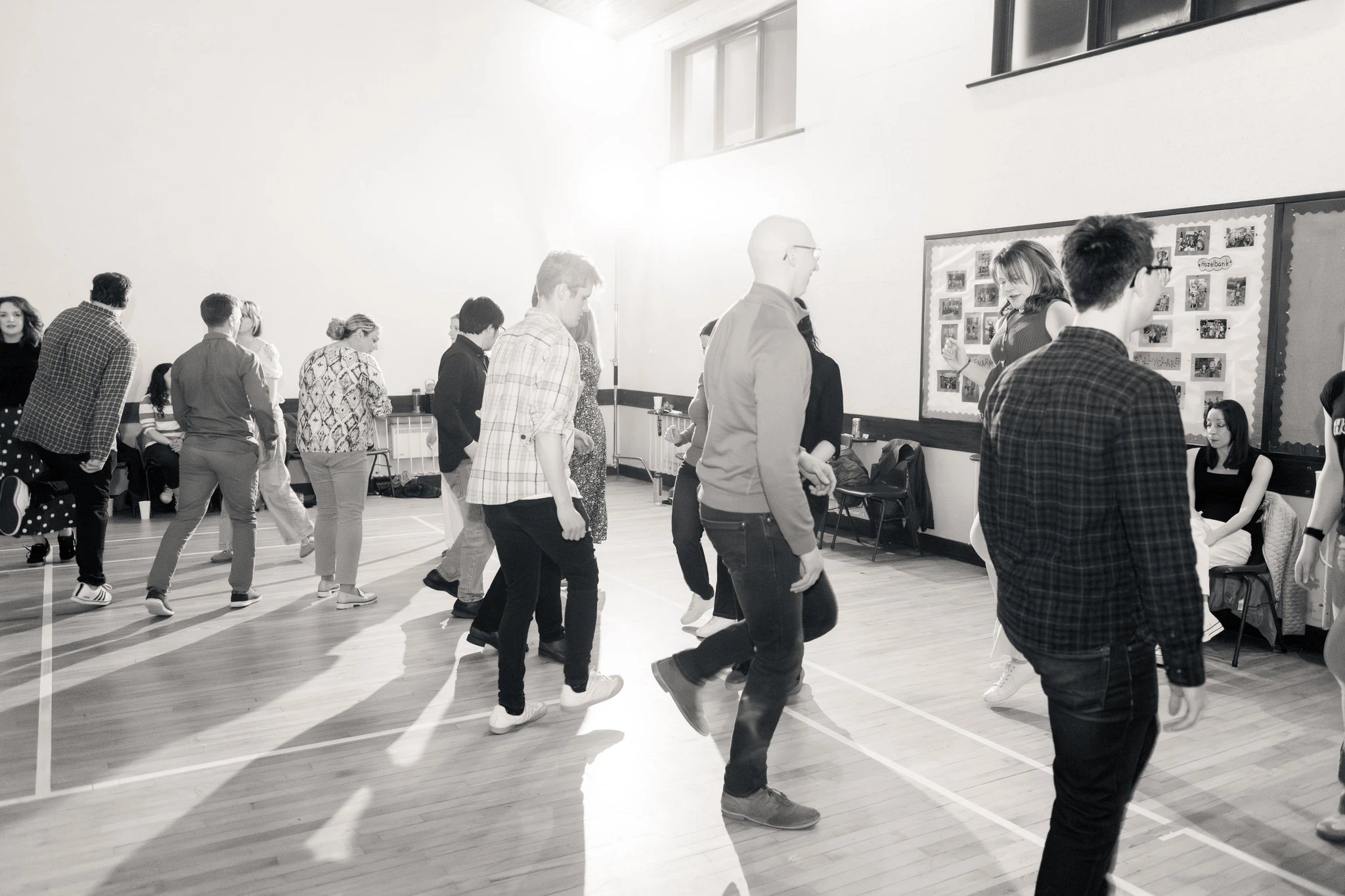 a group of people dancing in a gymnasium