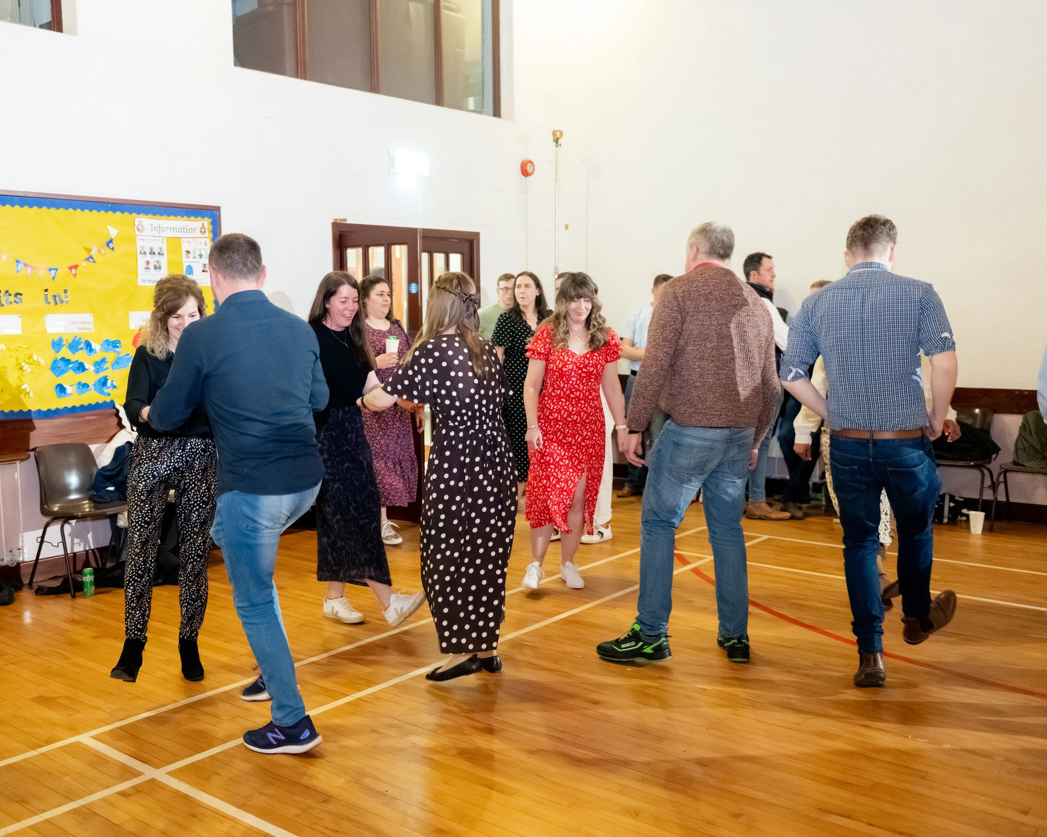 a group of people dancing in a room full of people