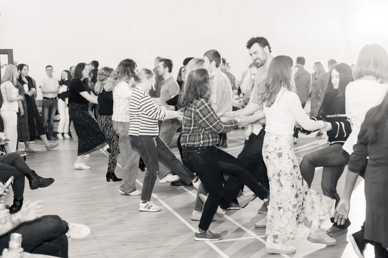 a group of people dancing in a room