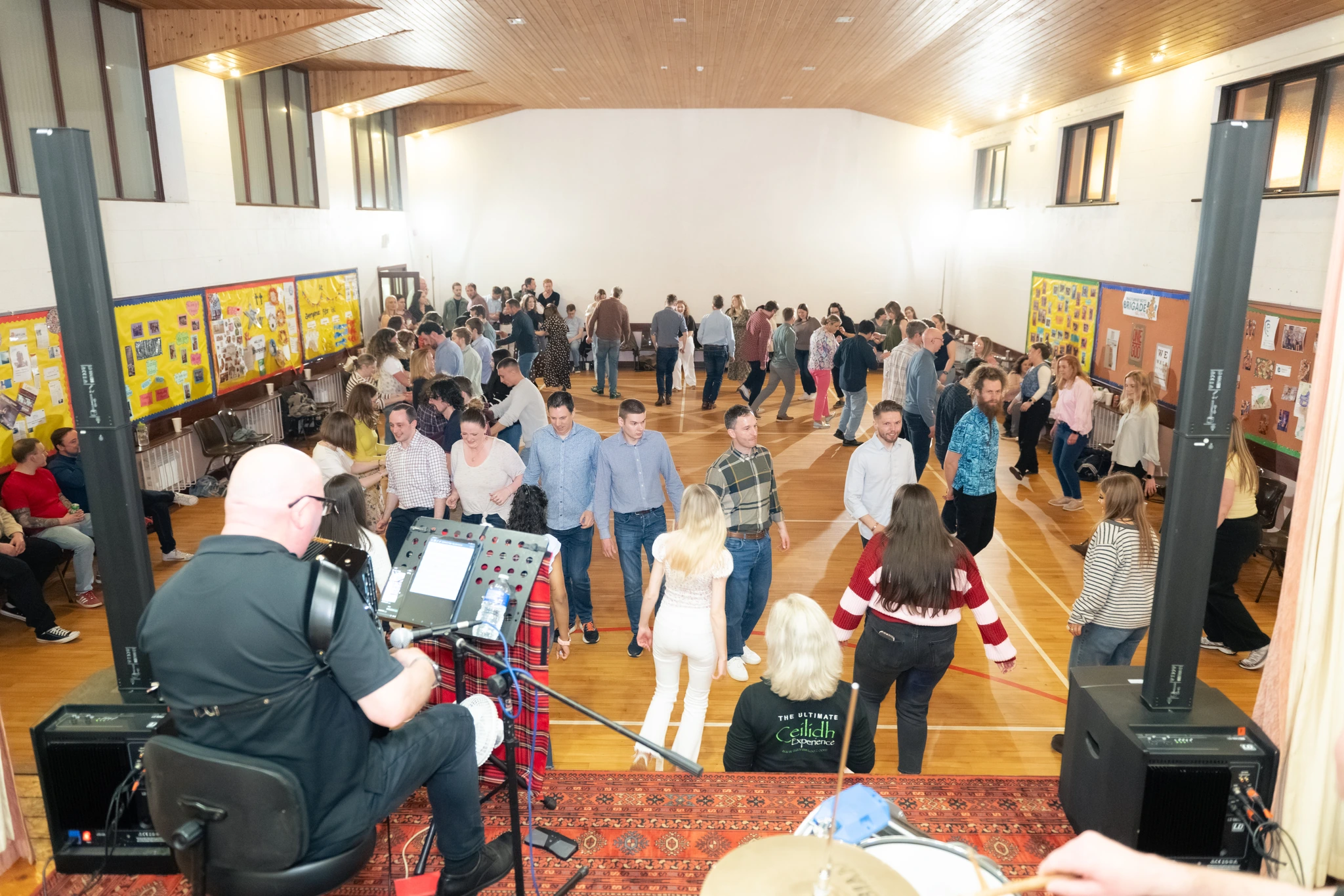 a group of people standing in a room with music playing