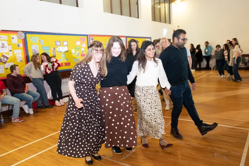 a group of people dancing in a gymnasium