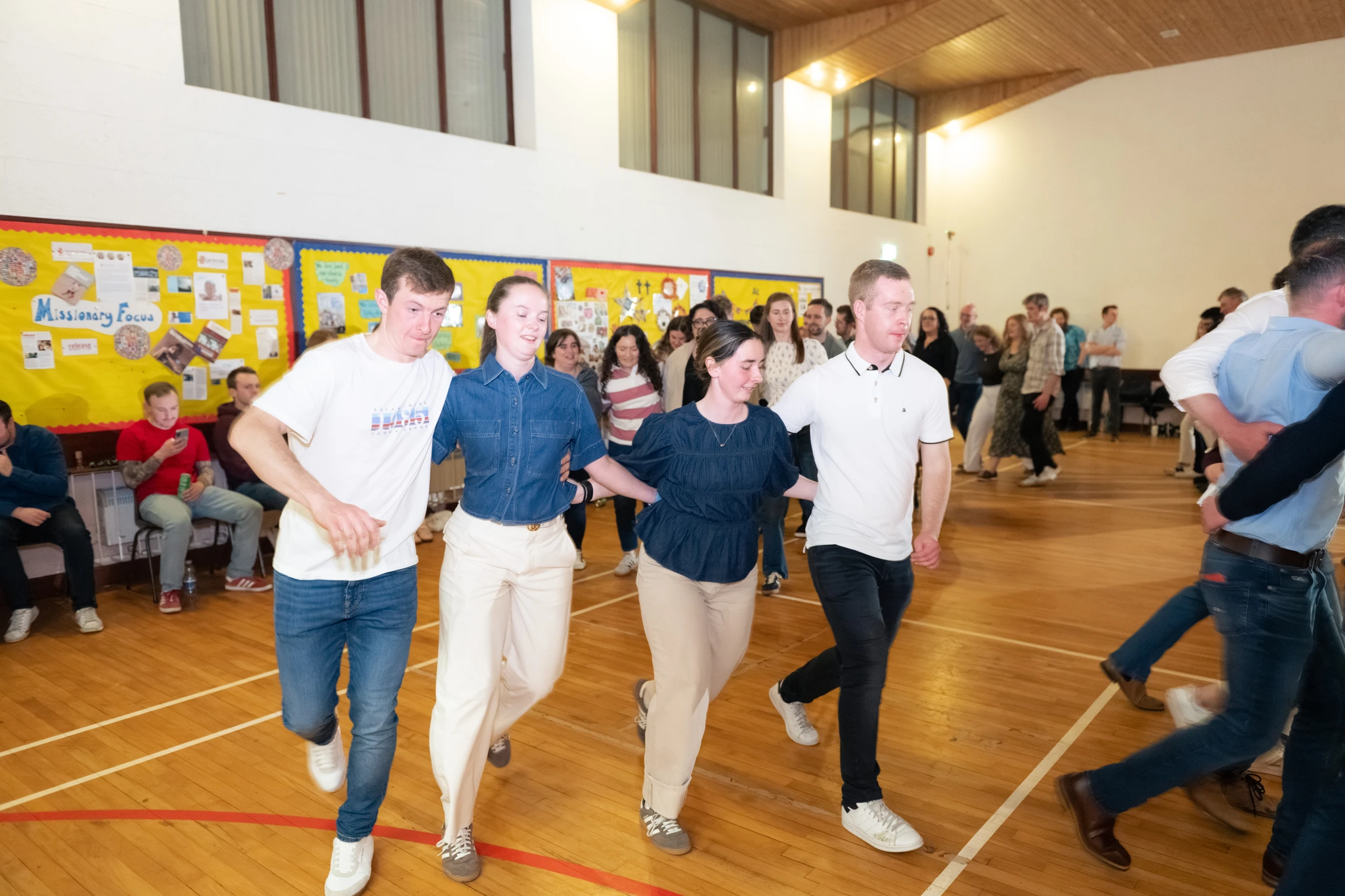 a group of people dancing in a gymnasium