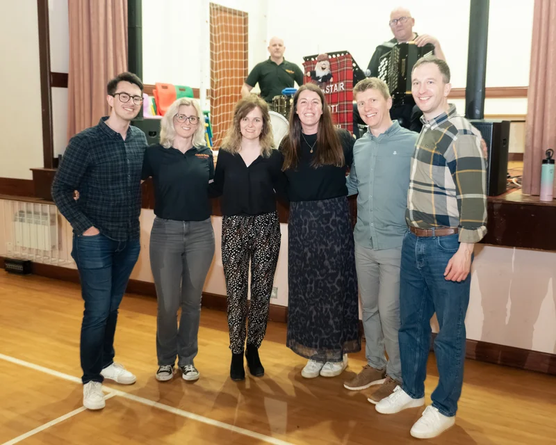a group of people standing next to each other in a room