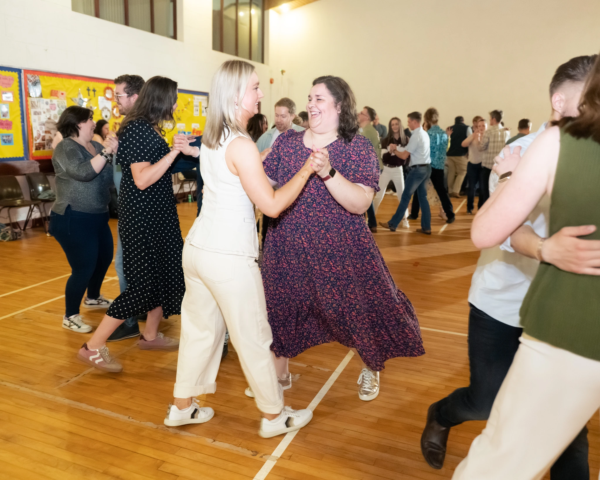 a group of people dancing in a gymnasium