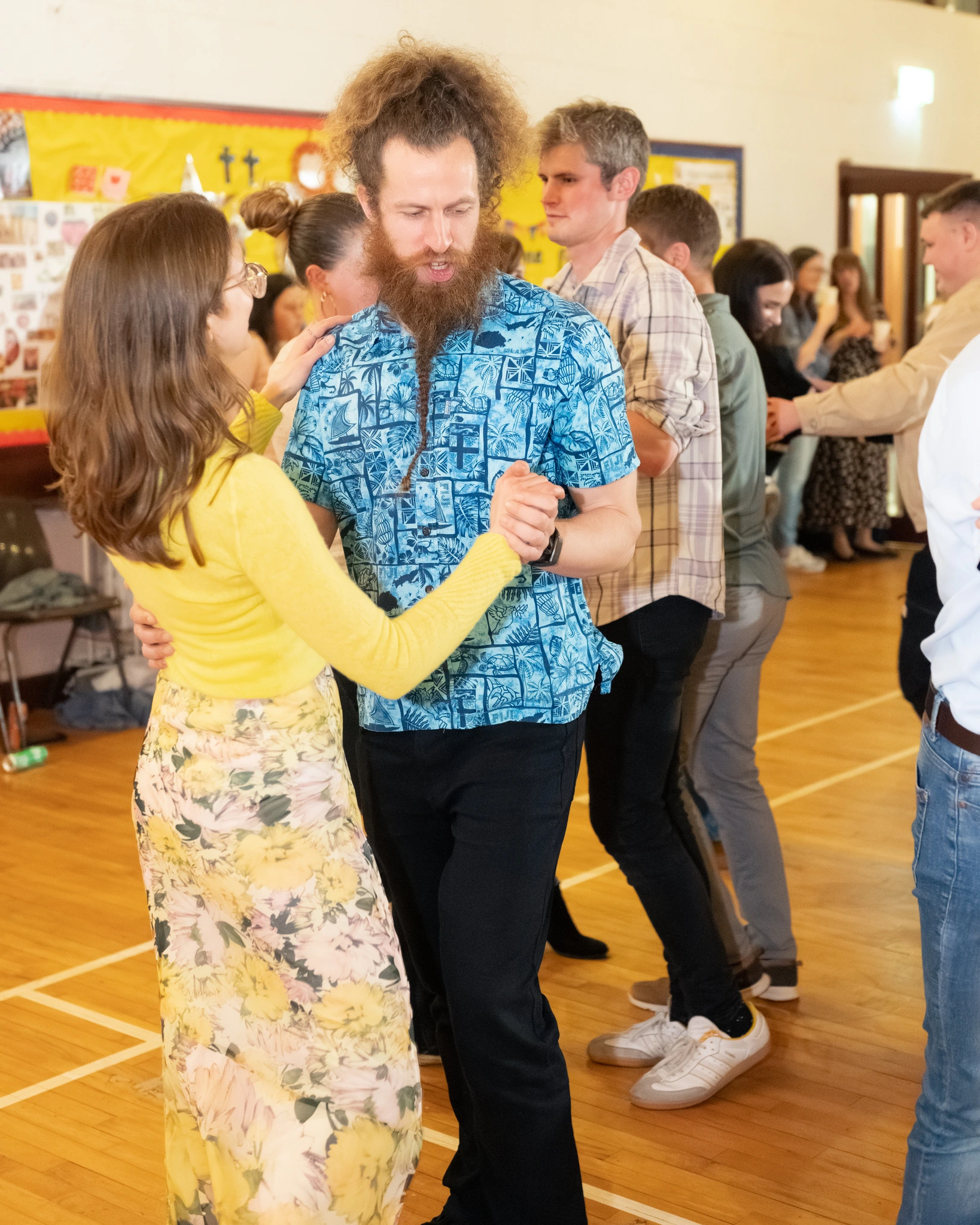a group of people dancing in a hall