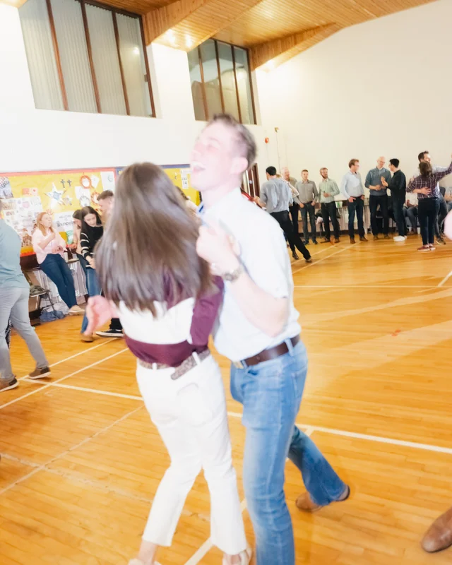 a group of people dancing in a gymnasium