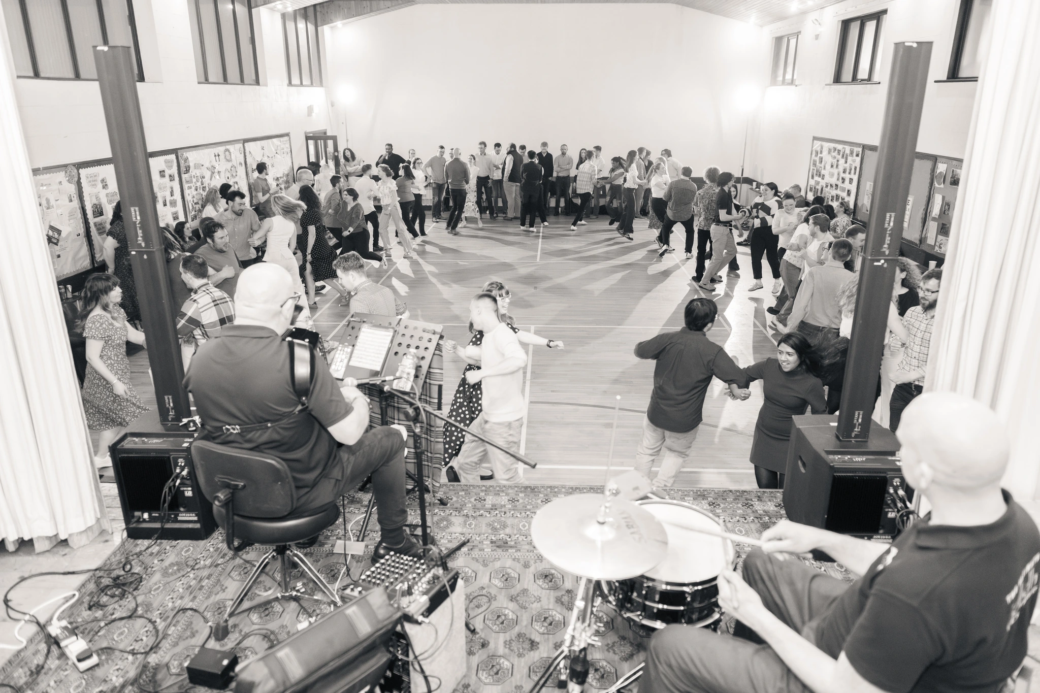a black and white photograph of a crowd watching a band perform