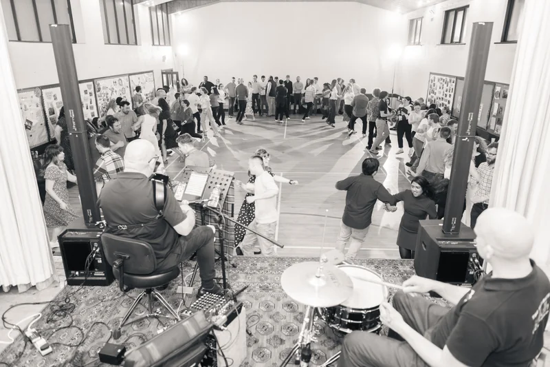 a black and white photograph of a crowd watching a band perform