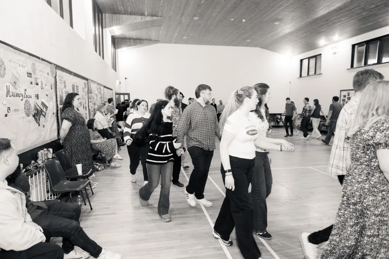 a group of people dancing on a dance floor