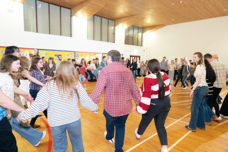 a group of people dancing in a circle