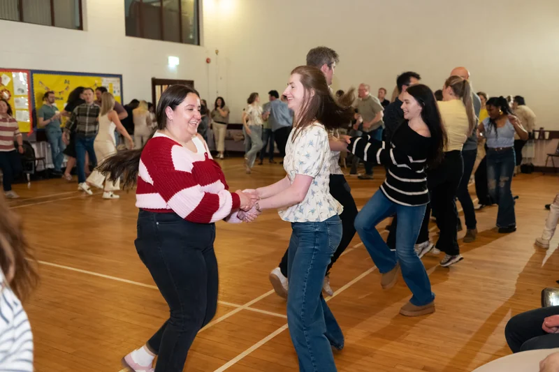 a group of people dancing in a room