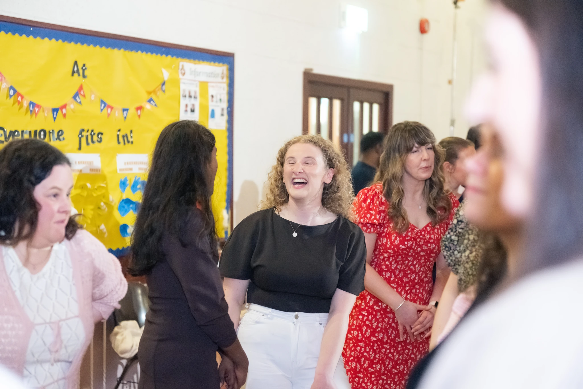 a group of people standing in front of a poster