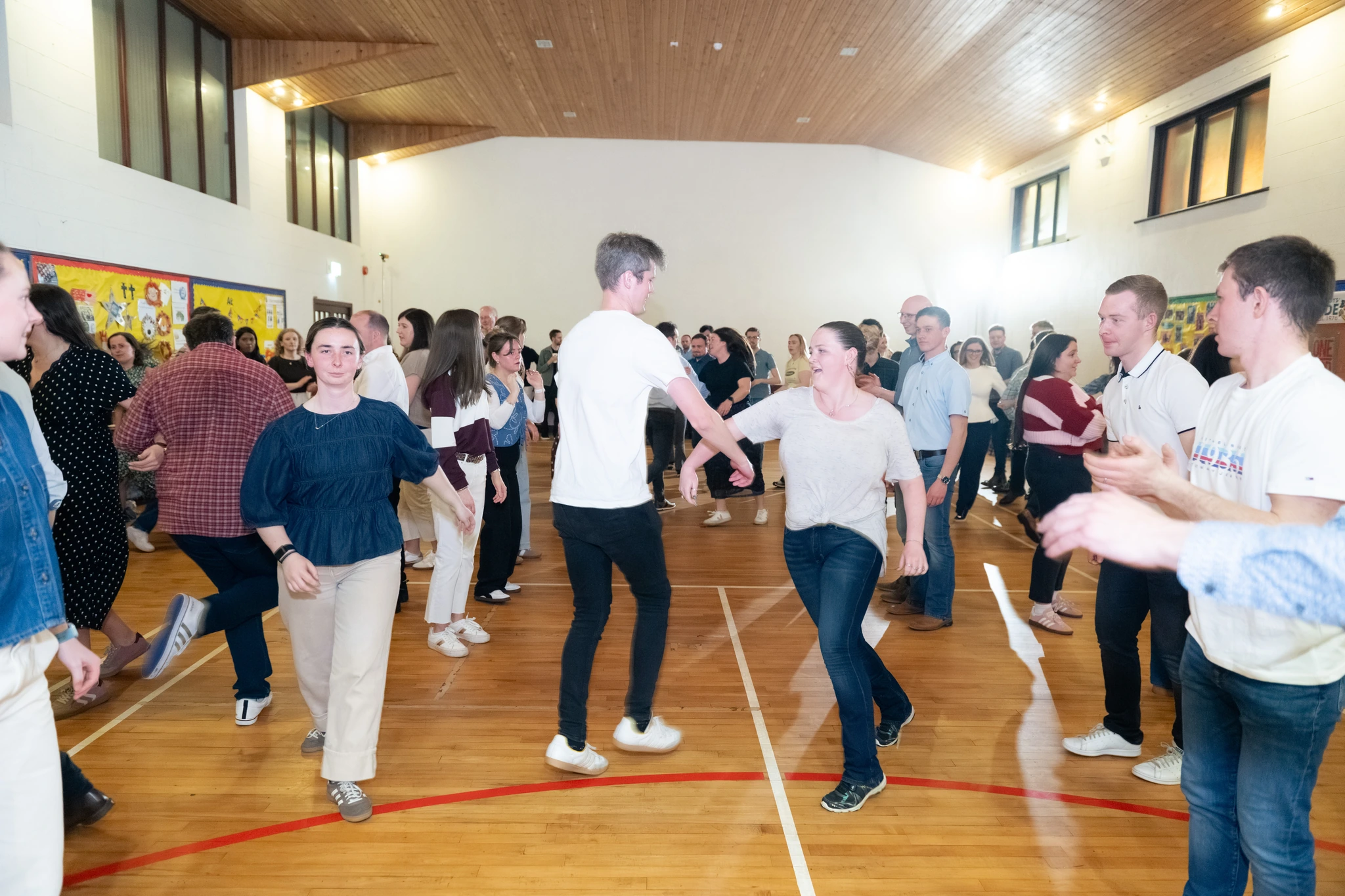 a group of people dancing in a gymnasium