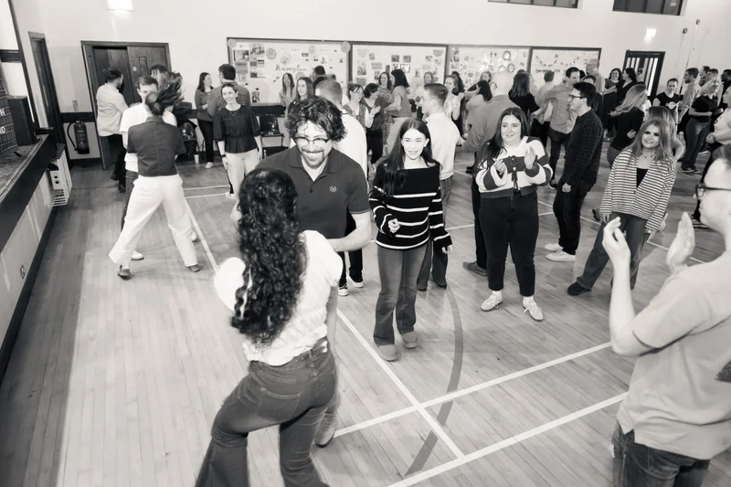 a group of people dancing in a gymnasium