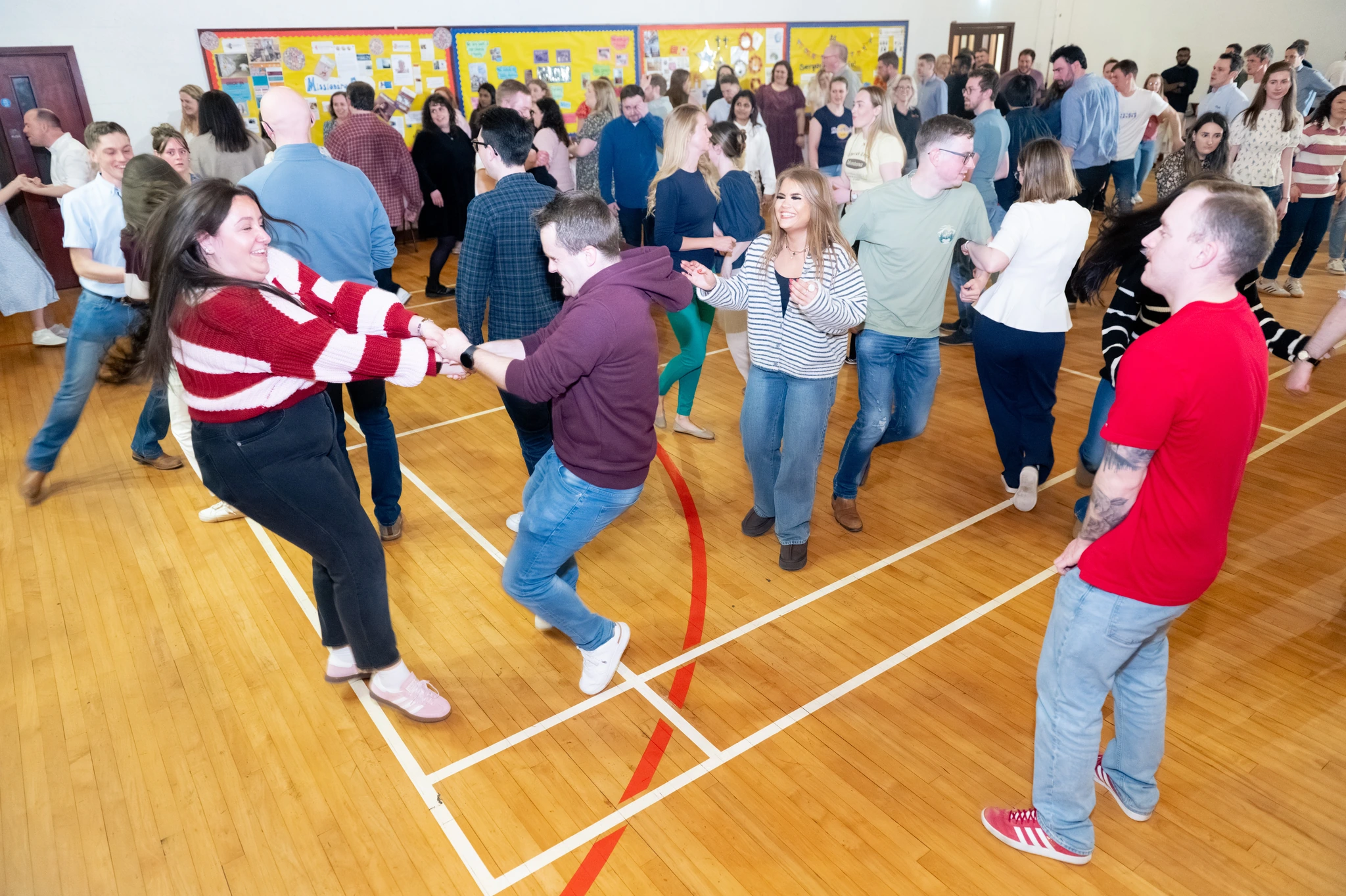 a group of people dancing in a gymnasium