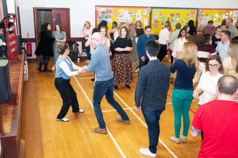 a group of people dancing in a room full of people